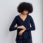 V neck style technical long sleeve top with cuffed sleeves and back pleat. Technical apparel by ADAY, perfect for travel.