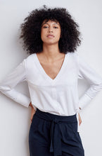 V neck style technical long sleeve top with cuffed sleeves and back pleat. Technical apparel by ADAY, perfect for travel.