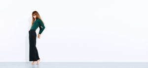 Technical forest green body suit with bonded seams, a high neck line + extra long sleeves