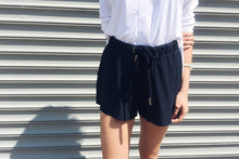 Navy technical silk inspired shorts with drawstring styled with a white button down shirt