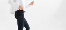 Midnight colored technical leggings with bonded seams, gunmetal zippers + a side phone pocket