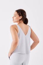 Got the Scoop Tank in Cloud colored technical silk with bonded hems and a v-shaped neckline