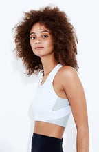 High impact minimal sports bra with bonded straps and a long front body